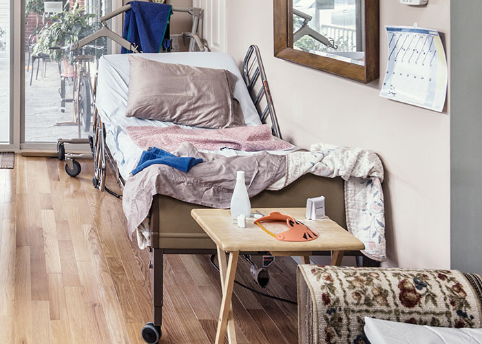 Picture of a man looking at a hospital bed